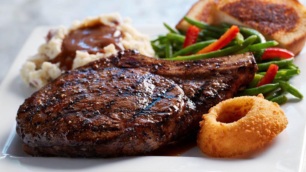 16 Oz. Choice Ribeye · A 16 oz. bone-in ribeye with excellent marbling, making each bite flavorful and juicy. Served with an O-Ring, grilled garlic bread, plus your choice of two regular sidecars.