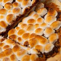 S'Mores Dessert Pizza · buttery graham cracker crumble topped with melted dark chocolate and toasted marshmallows