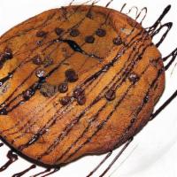 Chocolate Chunk Cookie Pie · a giant caramelized cookie overflowing with chocolate morsels served straight out of the ove...