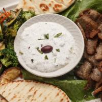 Gyros Platter With Small Caesar Salad & Pita Bread · A delicious combination of spring lamb and u.s. Prime beef and accented with an exotic blend...