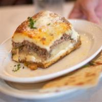 Moussaka With Small Caesar Salad & Pita Bread · Thin layers of eggplant and zucchini and Idaho potatoes sauteed in extra virgin olive oil an...