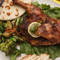 Roasted Chicken With Small Caesar Salad & Pita Bread · Marinated with a tantalizing blend of Mediterranean spices and slow roasted to perfection an...