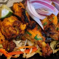 Tandoori Chicken · Marinated clay oven roasted whole chicken pieces.