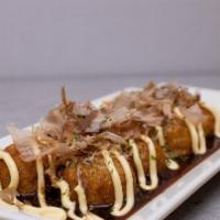 Takoyaki · Japanese octopus fried dough balls topped with sweet and tangy brown sauce, sweet Japanese m...