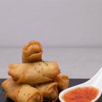 Spring Roll · Fried veggie spring rolls with a side of chili sauce.