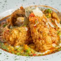 Fried Fish & Grits · Your choice of fried fish served over creamy grits. Garnished with diced multi-colored peppe...