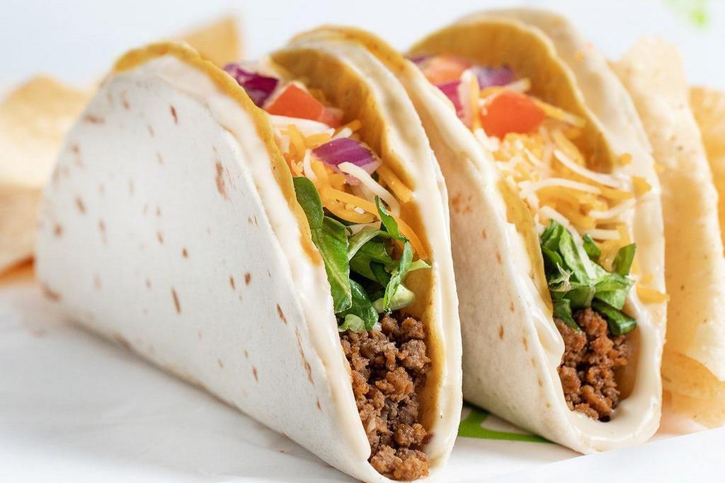 Double Wrapped Tacos · Two crispy shell tacos filled with your favorite toppings, all wrapped with a second soft shell and held together with refried beans or queso.