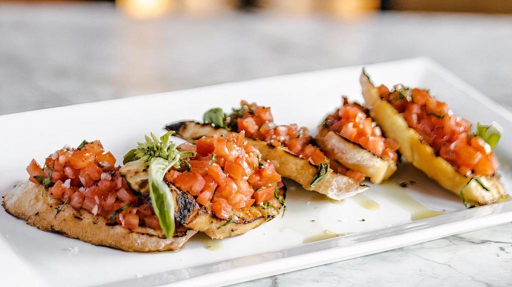 Bruschetta · Grilled ciabatta bread topped with chopped tomatoes and basil