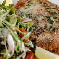 Chicken Milanese · Pan seared breaded chicken breast with baby arugula and cherry tomato
