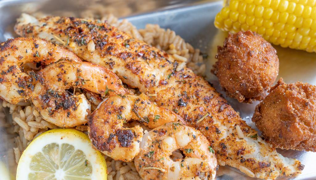 Blackened Cajun Combo · Fresh catfish and shrimp seasoned with our house blackened spices and seared on the grill. Served with 3 pcs of grilled catfish and 4 shrimp and plated best on a bed of Cajun rice, corn on the cob, and 2 hushpuppies. Side substitutions are available, choose any 2!