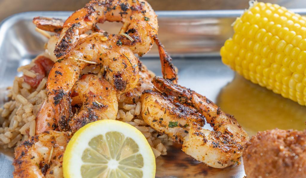Blackened Shrimp Dinner · Tail-on shrimp seasoned with our house blackened spices and seared on the grill. Served with 8 grilled shrimp plated best on a bed of Cajun rice, corn on the cob, and 2 hushpuppies. Side substitutions are available, choose any 2!
