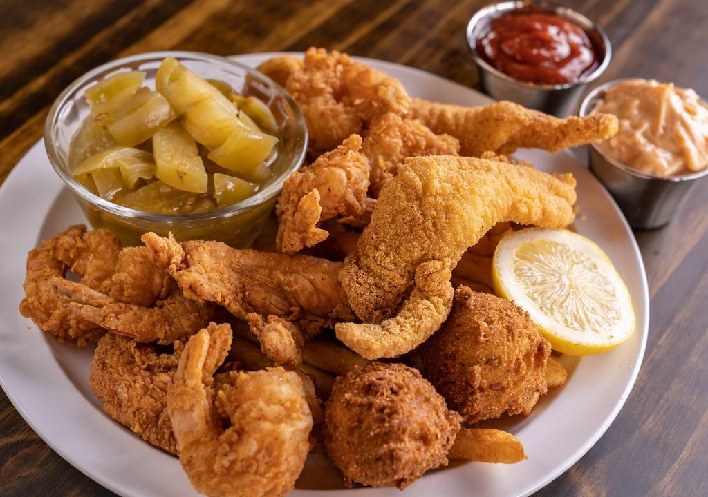 Try It All Combo · Two pieces U.S. farm-raised catfish, two pieces fresh, free-range Arkansas chicken tenders, and six of our hand-breaded shrimp fried to crisp perfection, served with two regular sides and hush-puppies.