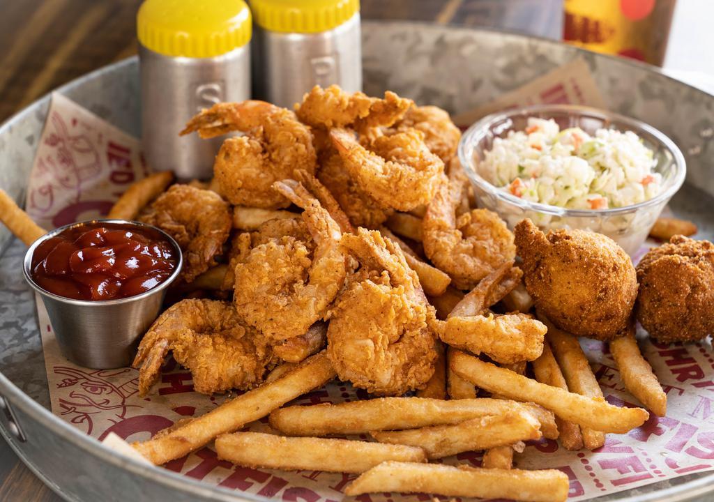 Fried Shrimp Dinner · Peeled and deveined, tail-on shrimp lightly hand-breaded in Cajun flour and fried to perfection, served two regular sides and hush-puppies.