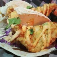 2 Baja Fish Tacos · Choice of tortilla, beer battered fish topped with red cabbage, pico and Baja sauce. Served ...
