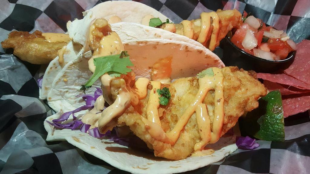 2 Baja Fish Tacos · Choice of tortilla, beer battered fish topped with red cabbage, pico and Baja sauce. Served with chips and salsa