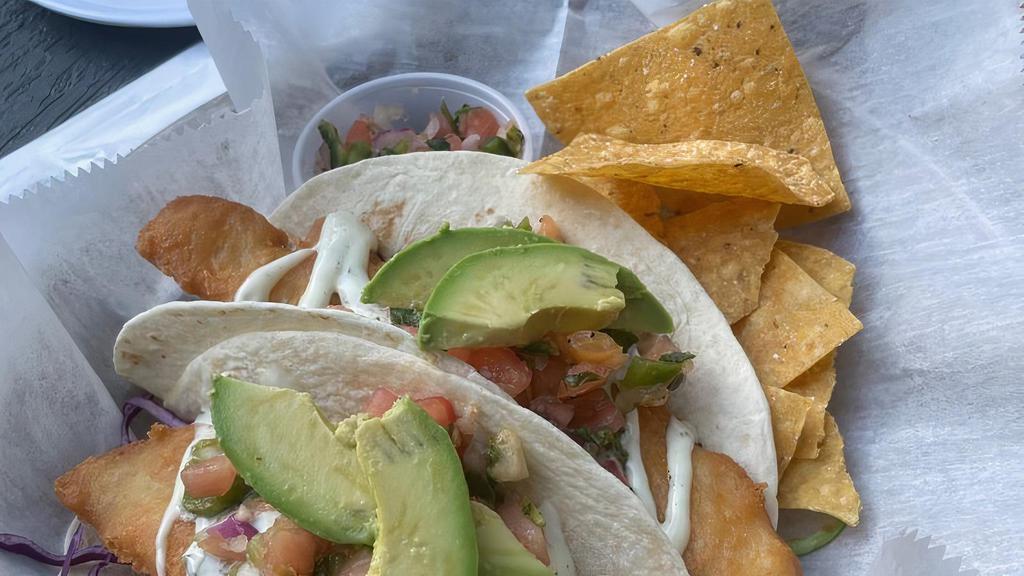 2 Key Lime Cilantro Fish Tacos · 2 beer battered fish, topped with red cabbage, cilantro lime ranch sauce, pico and fresh avocado.Choice of tortilla, served with chips and salsa