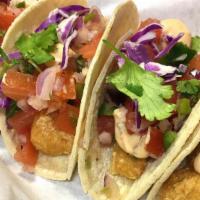 Vegan Baja Fish Tacos · 2 vegan fish tacos served on choice of tortilla, topped with pico, lettuce, cabbage and our ...