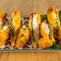 House Made Jalapeño Poppers · House made stuffed jalapeños with cream cheese and spices. Served with Baja sauce.