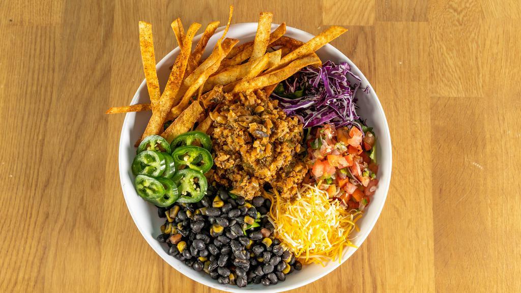 Taco Salad · Beyond crumbles or our no moo house made vegan No Moo dish, over mixed greens, pico, black bean corn salsa and vegan cheese with a side of chips. Served with guacamole and vegan Baja sauce.