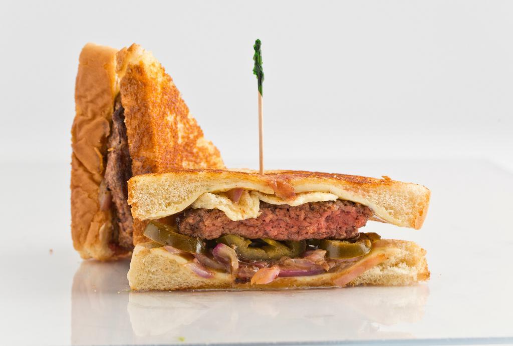 Texas Toast Burger · Topped with pepper jack cheese, grilled onions, and jalapenos on Texas toast.
