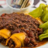 Chili & Tamales · Covered with cheddar cheese, red onions, and chili.