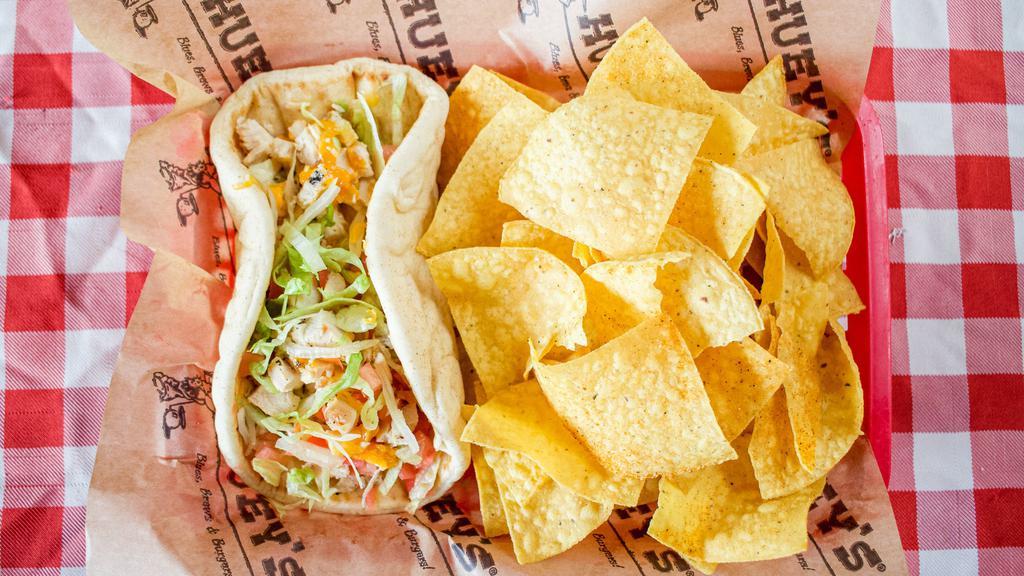 Fiesta Chicken Wrap · Grilled chicken breast strips marinated and lightly seasoned, folded in flat bread with grated cheddar cheese, lettuce, and tomato served with a side of tortilla chips, salsa and ranch.