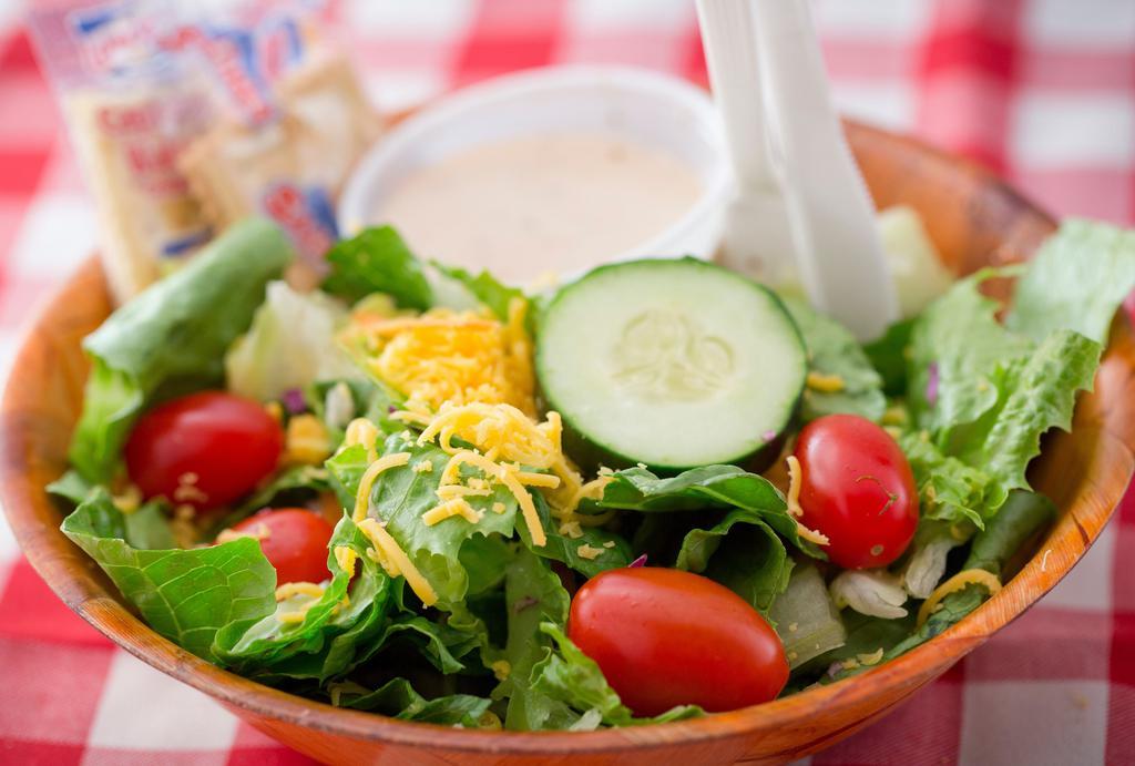Tossed Salad · Fresh mixed greens with grated cheddar cheese, grape tomatoes and cucumber.