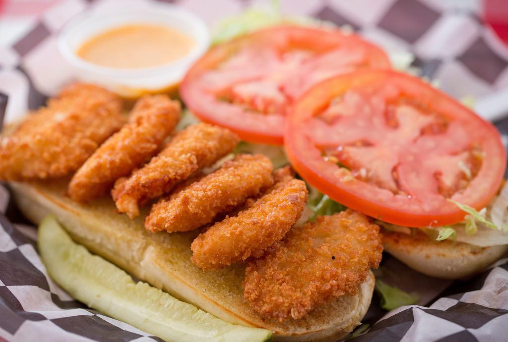 Shrimp Po-Boy · Breaded shrimp deep fried to a golden brown and served open face with lettuce and tomato on a buttered, toasted hoagie roll, with a side of remoulade sauce. (available buffalo style).