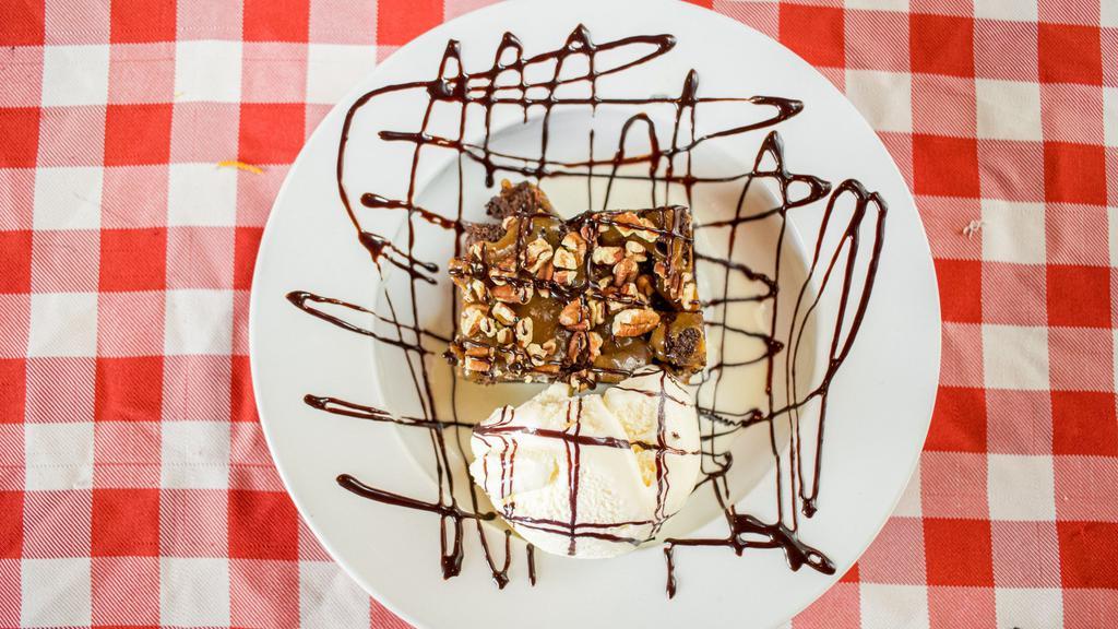 The Rock Slide · Melt in your mouth brownie topped with luscious caramel, brownie cubes, toasted pecans, and vanilla ice cream and drizzled with chocolate sauce.