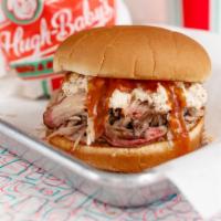 Pulled Pork Sandwich · Smoked pulled pork topped with coleslaw and hugh-baby's BBQ sauce.