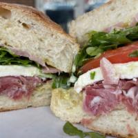 World'S Best Sandwich · Thinly sliced prosciutto, fresh mozz, seasoned tomato, arugula, pickled red onion, and pesto...