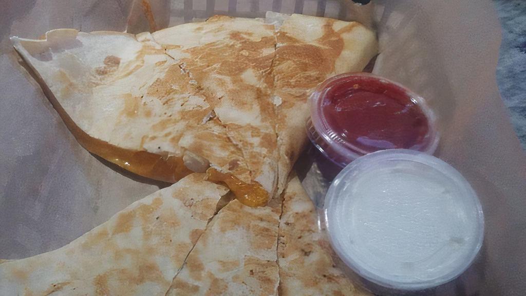 Chicken Quesadilla · House cut chicken, swiss and cheddar cheese, onioon, and bacon. Served with sour cream and salsa.