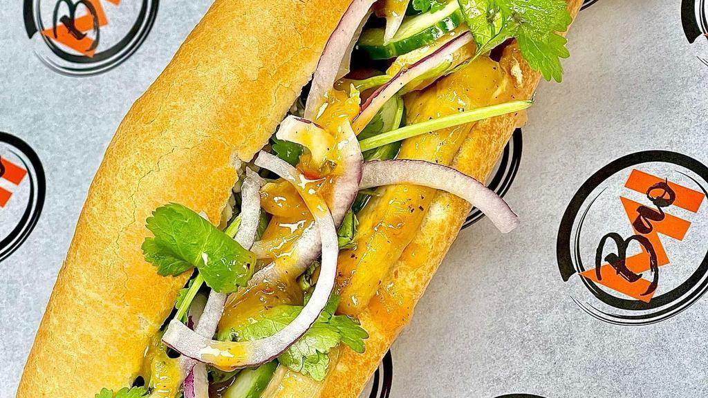 Tofu Banh Mi · Pickled carrots, pickled cucumbers, pickled jalapenos, shaved red onions, cilantro, and thai basil aioli.