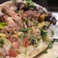 Carnitas Burrito · Slow roasted pork, Mexican rice, beans, guacamole, pico de gallo, shredded cheese, crema Mex...
