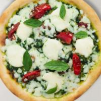 Pesto Pinolas Pizza · Our homemade pesto base, a bed of mozzarella cheese, fresh Roma tomato slices and artichoke ...