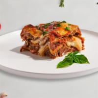 Lasagna  · Layers of pasta, ricotta, mozzarella, ground beef, and tomato sauce baked in an oven and top...