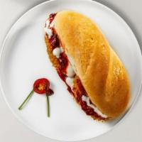 Chicken Parmesan Sub · A classic breaded chicken breast topped with tomato sauce, mozzarella cheese served in a hoa...