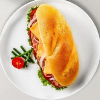 Ham And Swiss Sub · Hot or cold. Deluxe ham and imported baby Swiss cheese with red onions, shredded Iceberg let...