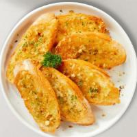 Garlic Bread · (Vegetarian) Housemade bread toasted and garnished with butter, garlic, and parsley.