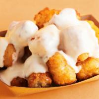 Cheesy Tots · Topped with real cheesy sauce.