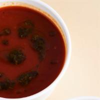 Roasted Red Pepper & Tomato Soup · Scratch-made vegan soup finished with basil and parsley gremolata.