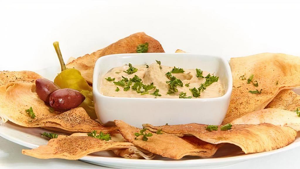 Hummus · Puree of chick peas, tahini, cumin, and lemon juice. Served with soft or baked pita chips.