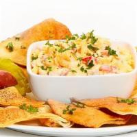 Spicy Pimento Cheese · Grated sharp Cheddar, mayonnaise, diced red peppers, and Tabasco. Served with soft or baked ...