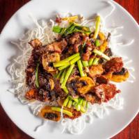 Mongolian Beef · Tender beef tossed with scallions, mushrooms and served in a sweet brown sauce over crispy r...