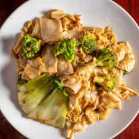 Pad See Eew · Wide rice noodles tossed with broccoli, eggs, and bok-choy in a thai brown sauce.