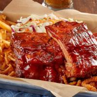 Baby Back Ribs - 1 Lb · Our fall-off-the-bone ribs in a sauce of your choice served with a side of fries and Vidalia...
