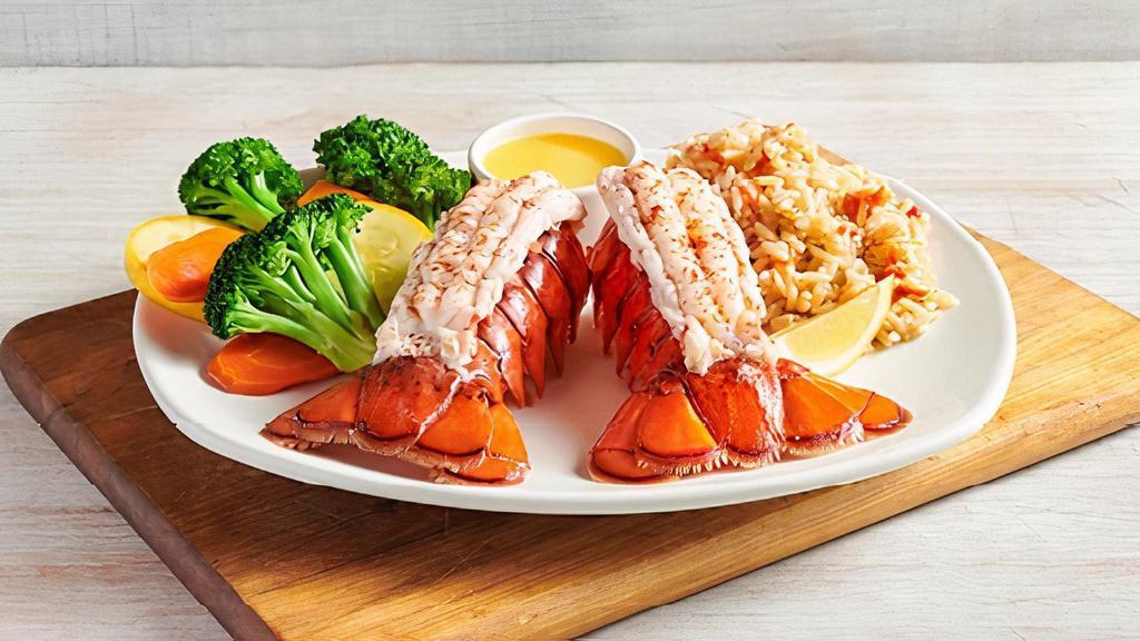 Lobster Tails · Two cold water tails perfectly steamed for maximum tenderness. Served with two freshly made sides.