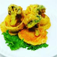 Vegetable Tempura · Lightly breaded, deep fried onion rings, broccoli, potato and sweet potato in a sweet tempur...