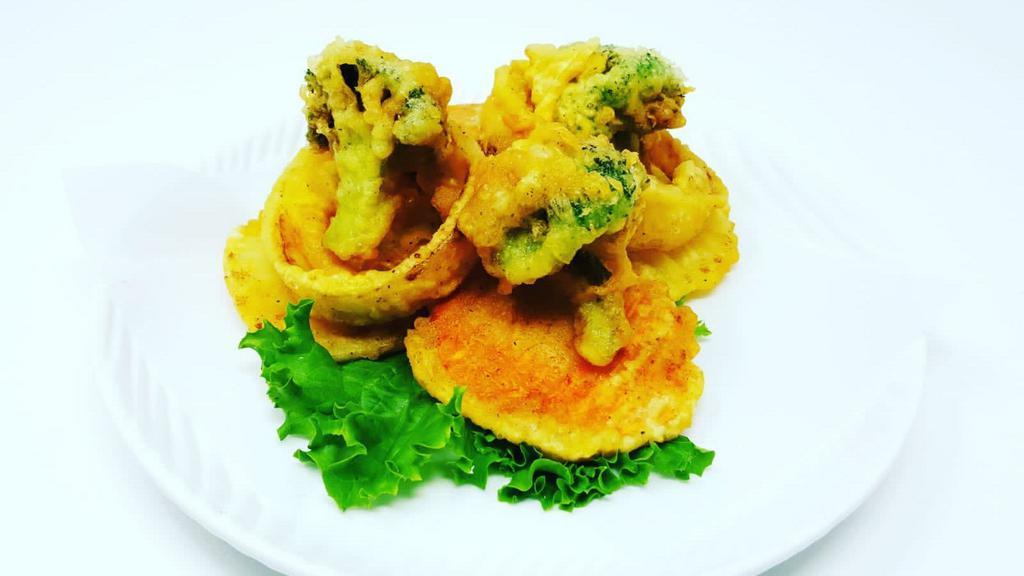 Vegetable Tempura · Lightly breaded, deep fried onion rings, broccoli, potato and sweet potato in a sweet tempura batter served with tempura sauce.