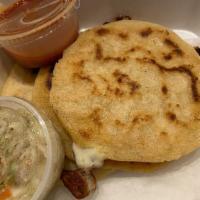 Pupusas · Served with curtido (cabbage slaw) and tomato sauce.